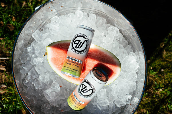 W Seltzer cans in an ice bucket with watermelon